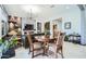 Cozy living room adjacent to dining area, with a stone accent wall, modern fireplace, and stylish decor at 19140 N 259Th Ave, Buckeye, AZ 85396