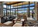 Open and airy lounge area with comfortable seating, stone accents, and expansive windows at 19140 N 259Th Ave, Buckeye, AZ 85396