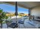 Inviting outdoor patio with a dining table, grill, and comfortable seating area, perfect for entertaining at 19140 N 259Th Ave, Buckeye, AZ 85396