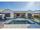 Backyard pool showcasing a patio, lounge chairs, and covered outdoor dining space at 19140 N 259Th Ave, Buckeye, AZ 85396