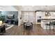 Open-concept dining area with wood floors next to a living room and a gourmet kitchen at 1929 S Follett Way, Gilbert, AZ 85295