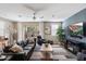 Stylish living room featuring a leather sofa, a ceiling fan and access to an outdoor patio at 1929 S Follett Way, Gilbert, AZ 85295