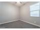 This bedroom features neutral gray paint and carpet and a bright, sunny window at 20039 S 231St St, Queen Creek, AZ 85142