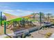 A vibrant playground with shade sails offers a fun and safe recreational space for children in the community at 20039 S 231St St, Queen Creek, AZ 85142