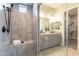 This tile shower features a rainfall shower head, a handheld sprayer, and a built-in bench at 20039 S 231St St, Queen Creek, AZ 85142