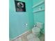 Stylish powder room featuring a toilet, wall shelves, and colorful wall decor at 2019 N 78Th Ave, Phoenix, AZ 85035