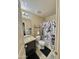 Bathroom with a vanity, toilet, and shower with black and white curtain at 2019 N 78Th Ave, Phoenix, AZ 85035
