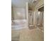 Bathroom featuring a separate tub and shower with glass door at 2019 N 78Th Ave, Phoenix, AZ 85035