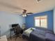 Bedroom with a ceiling fan, a window, blue walls and neutral carpet at 2019 N 78Th Ave, Phoenix, AZ 85035