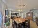Well-lit dining area next to kitchen featuring a wooden table with seating for six at 2019 N 78Th Ave, Phoenix, AZ 85035