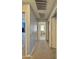 Neutral hallway showcasing access to the laundry room with washer and dryer at 2019 N 78Th Ave, Phoenix, AZ 85035