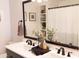 Bathroom featuring dual sinks with black fixtures and modern decor at 2113 E Glencove St, Mesa, AZ 85213