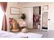 Bedroom featuring a chair, a plant and an open closet with many clothes at 2113 E Glencove St, Mesa, AZ 85213