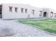 Beautiful home exterior with desert landscape, featuring low-maintenance gravel, grass, and architectural windows at 2113 E Glencove St, Mesa, AZ 85213