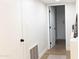 Hallway with wood flooring, a door, a small rug, and a console table at 2113 E Glencove St, Mesa, AZ 85213