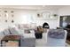 Cozy living room features a large sectional sofa, fireplace, and bright, neutral decor at 2113 E Glencove St, Mesa, AZ 85213