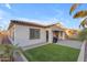 Spacious backyard with artificial turf, a built-in barbecue, and palm trees at 22837 E Silver Creek Ln, Queen Creek, AZ 85142