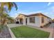 Large backyard with well maintained lawn, barbecue, and covered patio at 22837 E Silver Creek Ln, Queen Creek, AZ 85142