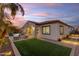 Beautiful backyard with manicured lawn, covered patio, and outdoor kitchen, ideal for entertaining and enjoying outdoor living at 22837 E Silver Creek Ln, Queen Creek, AZ 85142