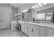 Elegant bathroom with a glass-enclosed shower, white cabinets, and large mirrors at 22837 E Silver Creek Ln, Queen Creek, AZ 85142