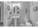 Bright bathroom featuring a single pedestal sink and a toilet at 22837 E Silver Creek Ln, Queen Creek, AZ 85142