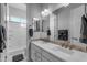 Bright bathroom featuring a double sink vanity with a decorative-tile backsplash and separate shower at 22837 E Silver Creek Ln, Queen Creek, AZ 85142