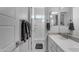 Neutral bathroom featuring a single sink and vanity, and a full shower with tile surround at 22837 E Silver Creek Ln, Queen Creek, AZ 85142