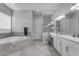 Luxurious bathroom featuring double vanity, soaking tub, tiled shower, and modern fixtures at 22837 E Silver Creek Ln, Queen Creek, AZ 85142