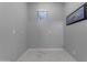 An empty bedroom with grey walls and white tiling at 22837 E Silver Creek Ln, Queen Creek, AZ 85142