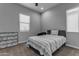 Bedroom featuring a grey bed, a marble patterned dresser, and two windows at 22837 E Silver Creek Ln, Queen Creek, AZ 85142