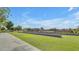 A well-maintained community park features green lawns, walking paths, and a glimpse of a pool area at 22837 E Silver Creek Ln, Queen Creek, AZ 85142