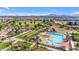 Aerial view of a community pool with lounge chairs, a playground and green space at 22837 E Silver Creek Ln, Queen Creek, AZ 85142