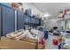 Cluttered garage with storage cabinets and shelves at 22837 E Silver Creek Ln, Queen Creek, AZ 85142