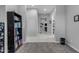 Hallway with grey and white tiling leading to multiple rooms with a carpeted entry at 22837 E Silver Creek Ln, Queen Creek, AZ 85142
