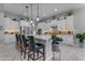 Modern kitchen with white cabinetry, a marble countertop island, and pendant lighting at 22837 E Silver Creek Ln, Queen Creek, AZ 85142