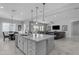 Open kitchen with a large island, stylish pendant lights, and an open layout at 22837 E Silver Creek Ln, Queen Creek, AZ 85142