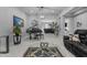 Spacious living room featuring elegant tile flooring, a piano, and stylish furnishings at 22837 E Silver Creek Ln, Queen Creek, AZ 85142