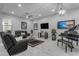 Comfortable living room featuring leather seating, a grand piano, and modern lighting at 22837 E Silver Creek Ln, Queen Creek, AZ 85142