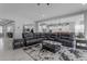 Open concept living room features lots of seating and seamless flow to the kitchen and dining room at 22837 E Silver Creek Ln, Queen Creek, AZ 85142