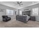 Main bedroom boasts a ceiling fan, plush carpeting, and large windows allowing for lots of natural light at 22837 E Silver Creek Ln, Queen Creek, AZ 85142
