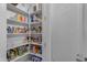 Walk-in pantry with ample shelving for storage and organization adjacent to the mud room at 22837 E Silver Creek Ln, Queen Creek, AZ 85142
