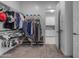 Spacious walk-in closet with shelving, hanging rods, and open access to laundry room at 22837 E Silver Creek Ln, Queen Creek, AZ 85142