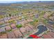Aerial view of a community with desert landscaping, tile roofs, and nearby green spaces at 2527 W Amber Sun Dr, Phoenix, AZ 85085