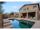 Backyard view featuring a rectangular pool with lounge chairs and covered patio space at 2527 W Amber Sun Dr, Phoenix, AZ 85085