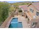 Aerial view of a sparkling pool, lush landscaping, and a cozy patio area at 2527 W Amber Sun Dr, Phoenix, AZ 85085