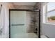 Bathroom featuring a tiled shower and bathtub with a sliding glass door at 2527 W Amber Sun Dr, Phoenix, AZ 85085