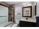 Bathroom featuring a tiled shower, toilet, and vanity with a mirror and sink at 2527 W Amber Sun Dr, Phoenix, AZ 85085