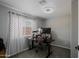 Cozy room is currently set up as an office, with a modern ceiling fan and patterned curtains at 2527 W Amber Sun Dr, Phoenix, AZ 85085