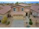 An aerial view of a two-story home showcases the front yard, desert landscaping, and a two car garage at 2527 W Amber Sun Dr, Phoenix, AZ 85085