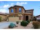 Two-story home with neutral stucco, arched entry, desert landscaping, and a two-car garage at 2527 W Amber Sun Dr, Phoenix, AZ 85085